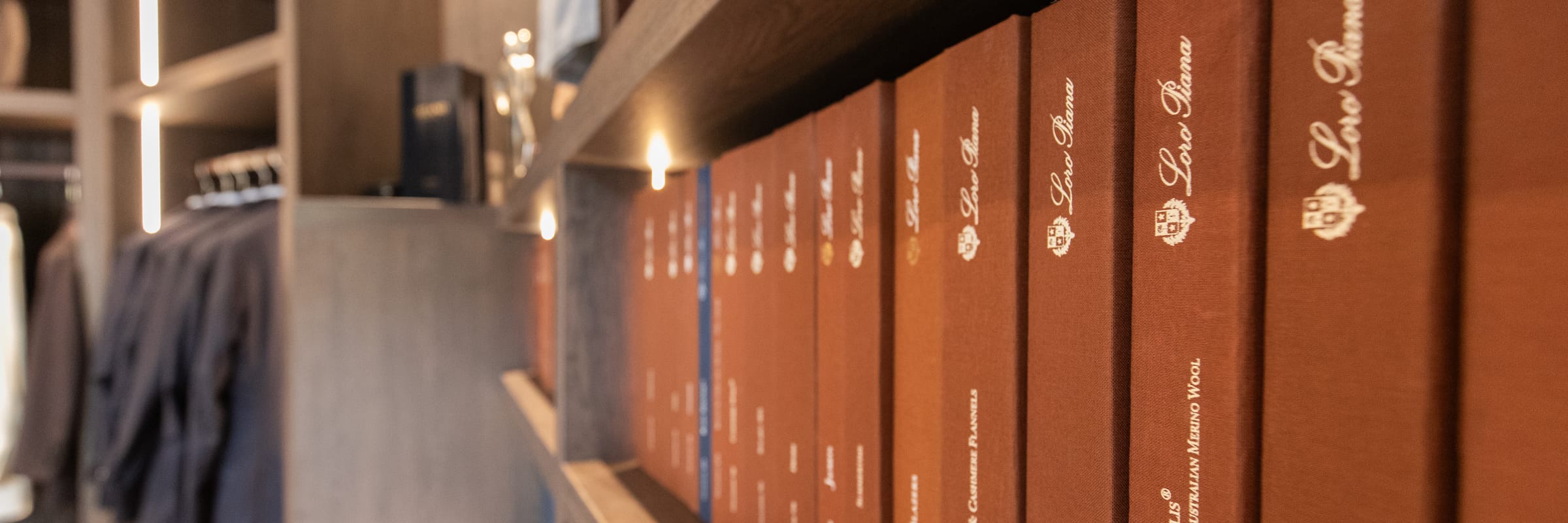 Stoffbücher von Loro Piana im Regal des LECIANO Showrooms